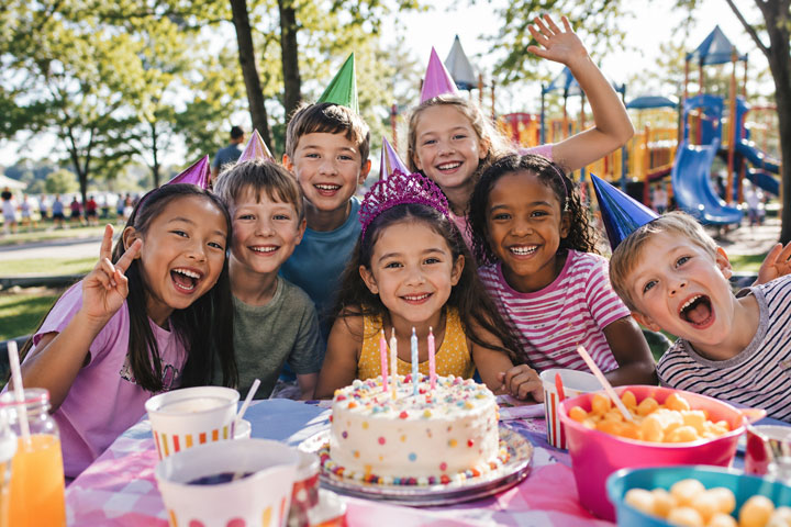 Kids birthday party table with cake, balloons, and simple decorations
